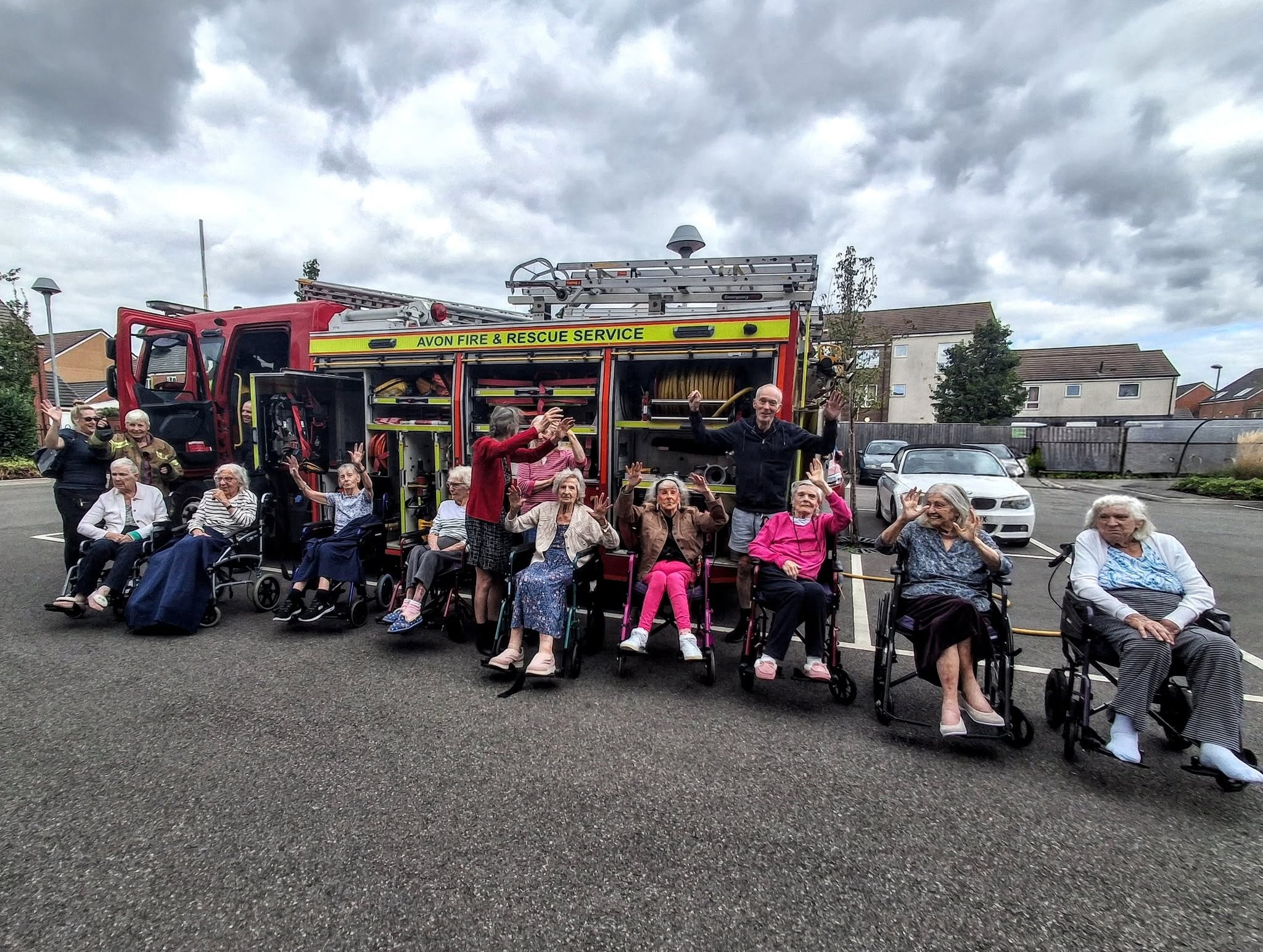 Care home residents outside with ems team