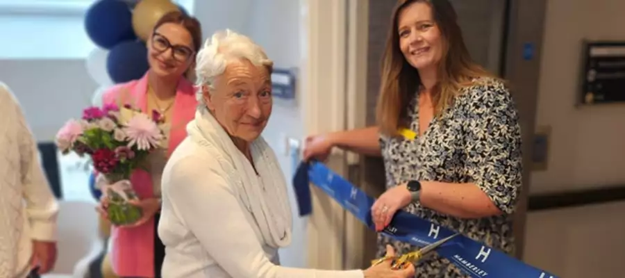 Resident Couple Cut The Ribbon At Cambridge Grove Luxury Suites Opening